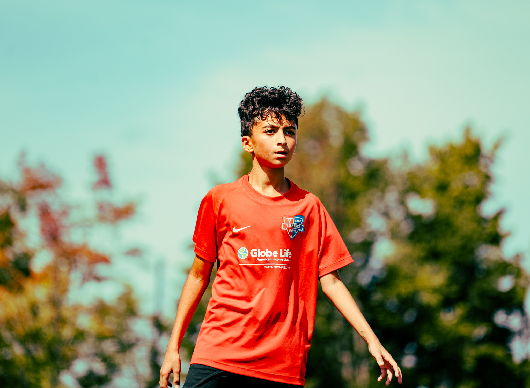 Vale Rush United player in a red jersey on the field